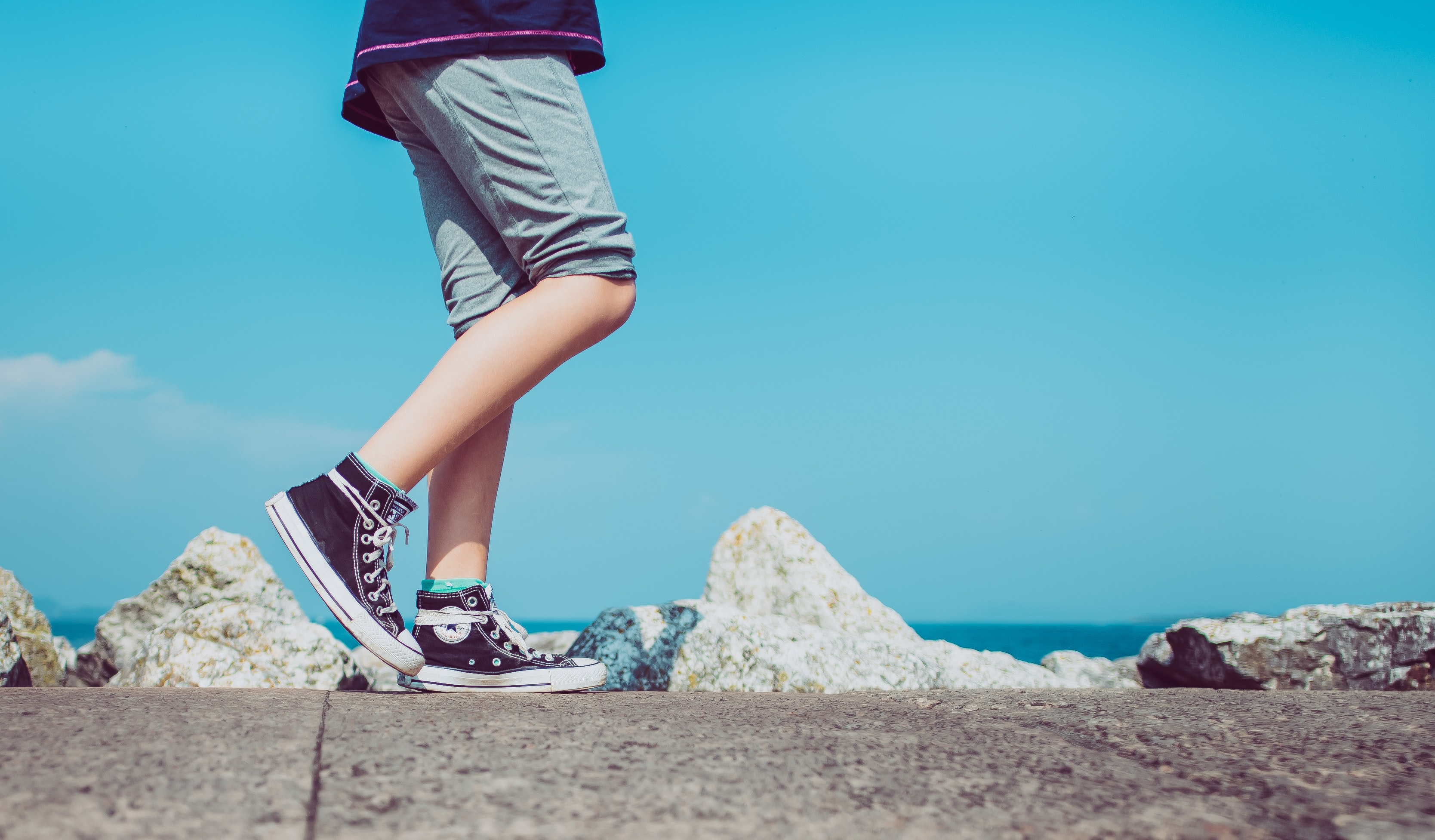 Persons legs and feet balancing on path